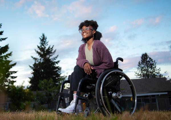 A smiling woman in a wheelchair